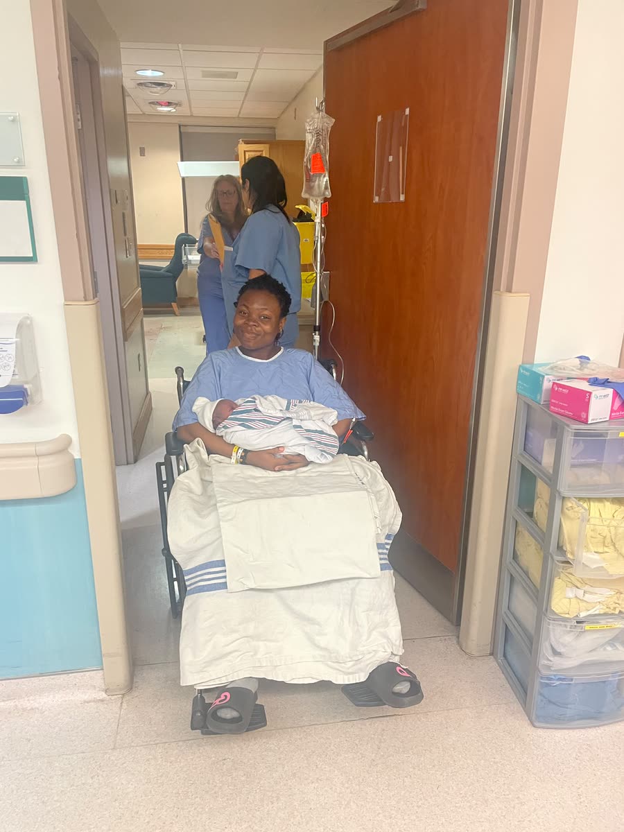 A new mother and her newborn leaving the maternity ward
