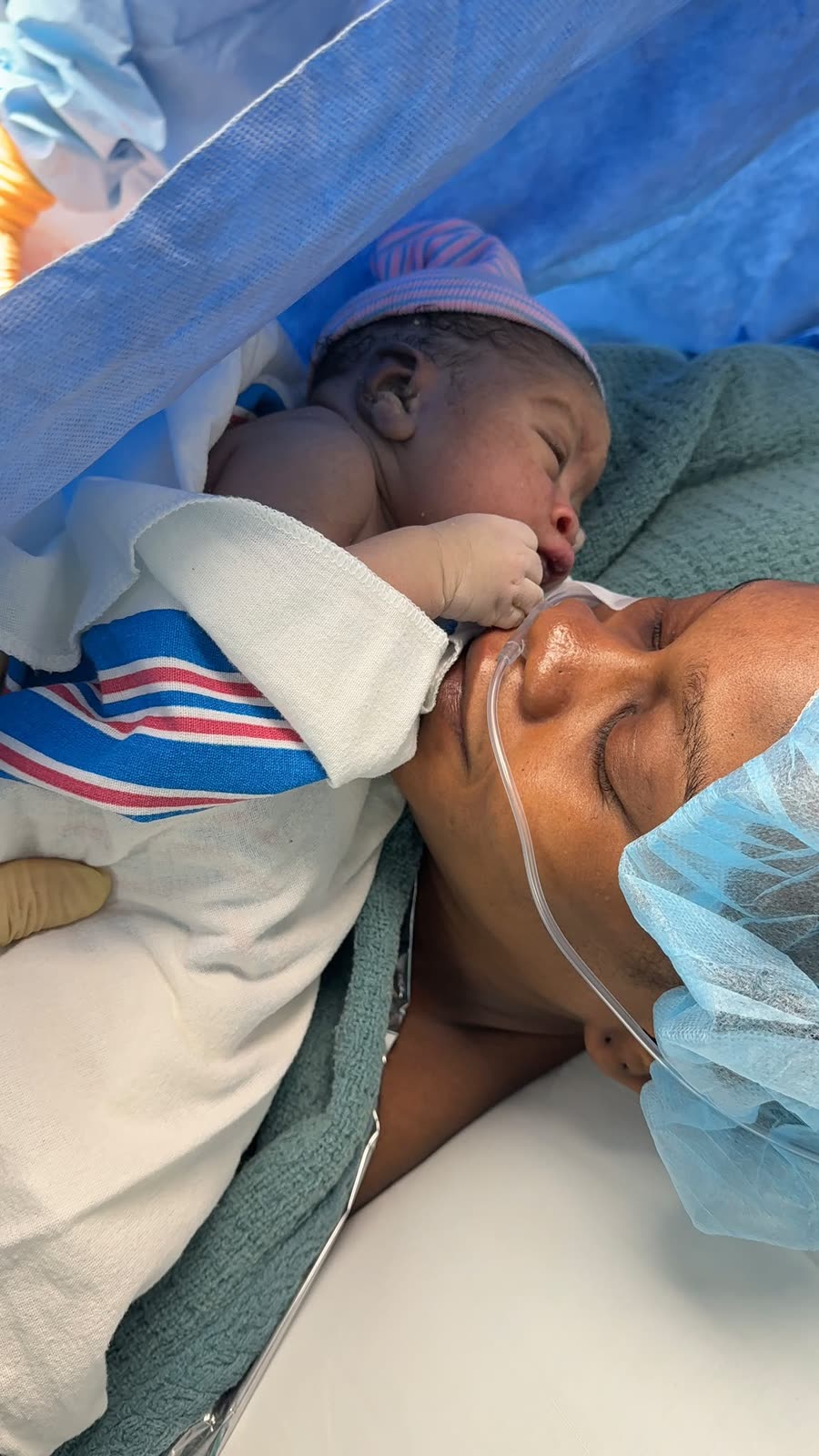 A mother holding her newborn skin-to-skin moments after birth