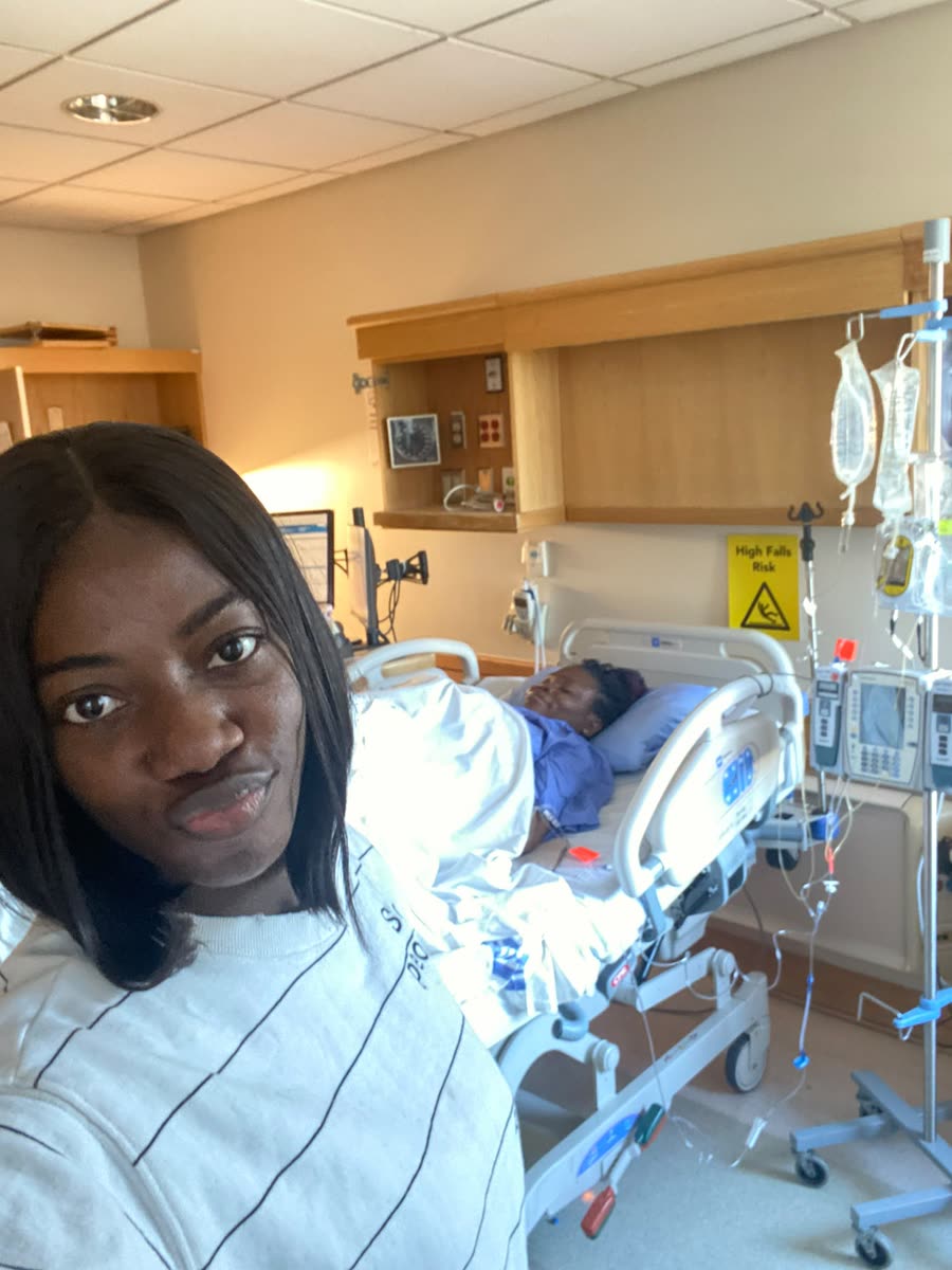 A new mother smiling in her hospital room